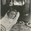 Margaret Sullavan lying by fireplace