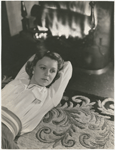 Margaret Sullavan lying by fireplace