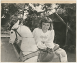 Margaret Sullavan with antique carousel horse