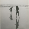 Bridget Hayward and Brooke Hayward running towards the water on the beach