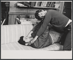 Tony Musante [on sofa] and Keir Dullea [standing] in the stage production P. S. Your Cat Is Dead!