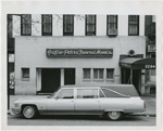 View of Griffin-Peters Funeral Home, in Harlem, New York, with funeral home's hearse parked in front