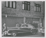 View of Unity Funeral Home, in Harlem, New York, as mourners are gathered outside