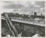 View of pedestrian and traffic overpass connecting West 155th Street to the Macombs Dam Bridge, in Harlem, New York, with the apartment buildings along Edgecombe Avenue visible in the background, ca. late 1940s