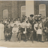 Booker T. Washington, with some of the teachers and trustees of the Tuskegee Institute, gathered in front of the Carnegie Library Building at Tuskegee Institute