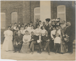 Booker T. Washington, with some of the teachers and trustees of the Tuskegee Institute, gathered in front of the Carnegie Library Building at Tuskegee Institute