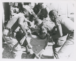Paratrooper from the 101st Airborne Brigade applying mouth-to-mouth resuscitation to an injured soldier who was airlifted by helicopter to the medical clearing station near Kontum, Vietnam