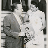 Tennis player Althea Gibson with New York City mayor Robert F. Wagner, posing with copy of Gibson's record album "Althea Gibson Sings" 