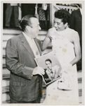 Tennis player Althea Gibson with New York City mayor Robert F. Wagner, posing with copy of Gibson's record album "Althea Gibson Sings" 