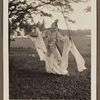 Edith James Long outdoors wearing Chinese costume with long scarves draped over her wrists.