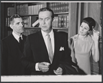 Ray Milland [center] and unidentified others in the stage production Hostile Witness
