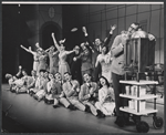 Charles Nelson Reilly [right] and ensemble in the stage production How to Succeed in Business Without Really Trying