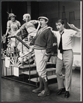 Jeff De Benning, Ronnie Welsh and ensemble in the stage production How to Succeed in Business Without Really Trying