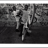 Boys popping wheelies on bicycles