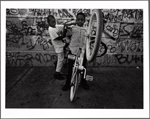 Boys popping wheelies on bicycles