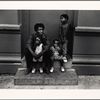 Father and three children sitting on a step