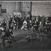 Zero Mostel [at left foreground in center in group of three], Sam Levene [in front of Mostel], Mildred Natwick [left of center in patterned dress], Diane Cilento [right of center in black dress], director Garson Kanin [center with arms raised], Ernest Truex [fourth from right with legs crossed], Ruth Gordon [third from right in plaid skirt ] and ensemble in rehearsal for the stage production of The Good Soup
