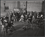 Zero Mostel [at left foreground in center in group of three], Sam Levene [in front of Mostel], Mildred Natwick [left of center in patterned dress], Diane Cilento [right of center in black dress], director Garson Kanin [center with arms raised], Ernest Truex [fourth from right with legs crossed], Ruth Gordon [third from right in plaid skirt ] and ensemble in rehearsal for the stage production of The Good Soup