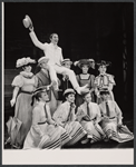 Tony Tanner (waving hat) and company in the stage production Half a Sixpence