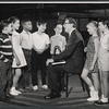 Valerie Lee (2nd from left), composer Meredith Willson (seated), and unidentified child performers in rehearsal for the stage production Here's Love