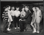 Valerie Lee (2nd from left), composer Meredith Willson (seated), and unidentified child performers in rehearsal for the stage production Here's Love
