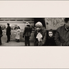 Four People on Platform - Train Conductor in Cap, Man in Sports Hat - Train Passing: Woman with White Headscarf, Frightened Little Girl, Hispanic Man in Check Coat - Seated