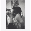 Series # 20 [Man tying bandage around wrist with teeth]