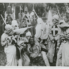 Klansmen surround freedman Gus (played by white actor Walter Long in blackface) in a scene"The Birth of a Nation."