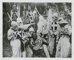 Klansmen surround freedman Gus (played by white actor Walter Long in blackface) in a scene"The Birth of a Nation."