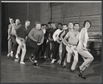 Arik Lavie [center] and ensemble in rehearsal for the stage production Irma La Douce