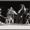 Alec Guiness [center] and ensemble in the stage production Dylan
