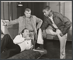 Director Robert Rossen [standing], Gene Boland [standing with foot on mattress] and unidentified [laying on mattress] in rehearsal for the stage production The Cool World