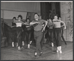 Director-choreographer Michael Kidd (front and center) leads the company in rehearsal for the stage production Destry Rides Again