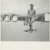 Paul Jacobs on the beach carrying picnic basket