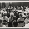 Frederick Loewe [at piano], Alan Jay Lerner [dark glasses], Moss Hart [center table] and ensemble in rehearsal for the stage production Camelot