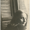 Tanaquil Le Clercq in an informal pose looking over her shoulder with window and shutter in background