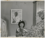 Philippa Schuyler (center) sitting for her mother Josephine, who is painting a portrait of her, circa 1944-45. A portrait of George Schuyler, also painted by Josephine, hangs on wall behind Philippa.