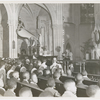 Priest delivering sermon during a religious service held at St. Charles Borromeo Church, in Harlem, New York City, circa late 1940s