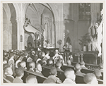 Priest delivering sermon during a religious service held at St. Charles Borromeo Church, in Harlem, New York City, circa late 1940s
