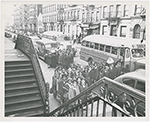 View of two busloads of Catholic school children arriving for class at St. Charles Borromeo Church, on West 142nd Street, in Harlem, New York City, circa late 1940s