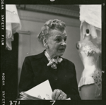 Barbara Karinska talking with mannequin in the background.