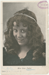 Studio head shot of Loie Fuller with string of pearls in her hair.