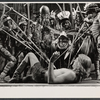 Ted LePlat [lying supine] and unidentified others in the stage production The Leaf People