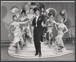 Performer and ensemble in the stage production The Merry Widow