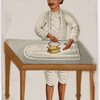 Male servant ironing on table