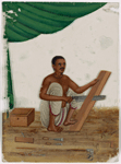 Seated male carpenter sawing a wood board, with tools on the ground