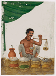 Seated male spice/salt vendor holding a balance