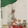 Seated male food vendor roasting meat on spit, fanning flames