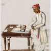 Man in white ironing at table