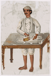 Man in white ironing behind table